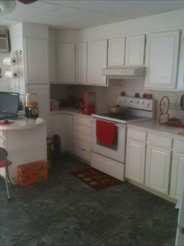 242 Madison St, Waterbury, CT 06706 - kitchen with electric range, under cabinet range hood, light countertops, and white cabinetry