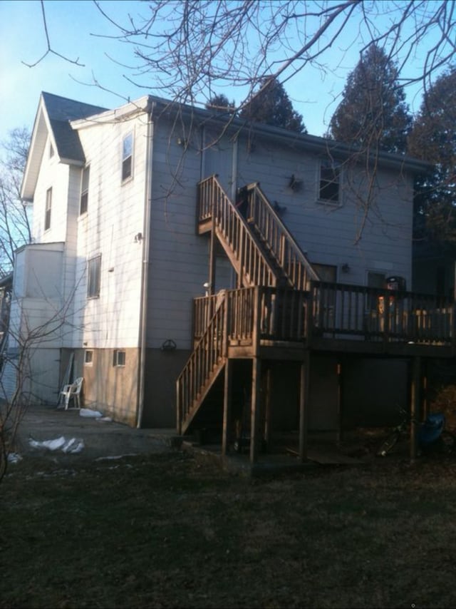 242 Madison St, Waterbury, CT 06706 - rear view of house featuring stairway, a wooden deck, and a lawn