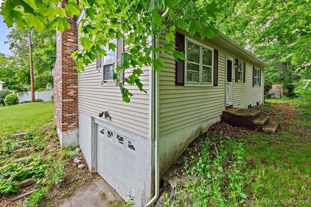 3 Pattagansett Ct, East Lyme, CT 06357 - view of side of home featuring a garage, driveway, and a lawn