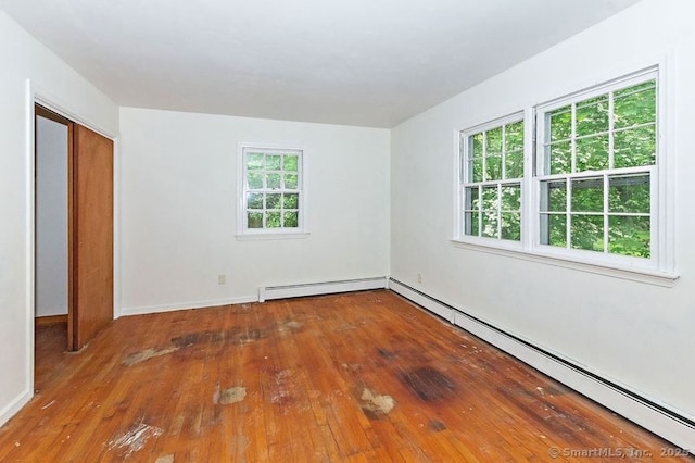 3 Pattagansett Ct, East Lyme, CT 06357 - unfurnished bedroom featuring baseboard heating, hardwood / wood-style floors, and baseboards