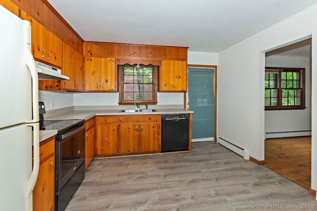 3 Pattagansett Ct, East Lyme, CT 06357 - kitchen featuring black appliances, under cabinet range hood, a sink, and a baseboard heating unit