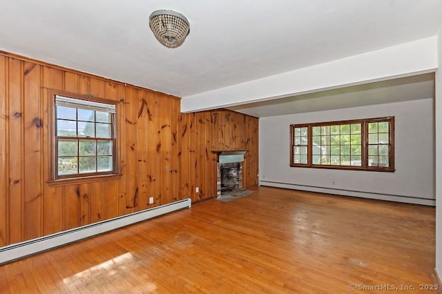 3 Pattagansett Ct, East Lyme, CT 06357 - unfurnished living room featuring baseboard heating, a baseboard heating unit, a fireplace with flush hearth, wood finished floors, and beamed ceiling