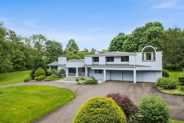 37 Topfield Rd, Wilton, CT 06897 - view of front of house with asphalt driveway, covered porch, a garage, a chimney, and a front yard