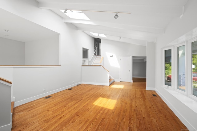 37 Topfield Rd, Wilton, CT 06897 - spare room with a skylight, rail lighting, wood finished floors, baseboards, and stairs