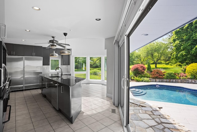 37 Topfield Rd, Wilton, CT 06897 - kitchen with a sink, dark cabinetry, stainless steel built in fridge, black dishwasher, and an island with sink
