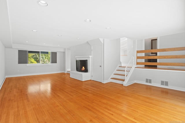 37 Topfield Rd, Wilton, CT 06897 - unfurnished living room featuring stairs, a fireplace, light wood-type flooring, recessed lighting, and baseboards