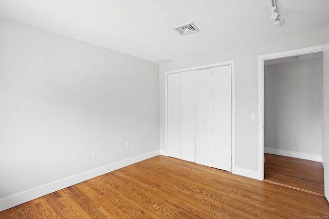 37 Topfield Rd, Wilton, CT 06897 - unfurnished bedroom with light wood-style flooring, baseboards, a closet, and track lighting