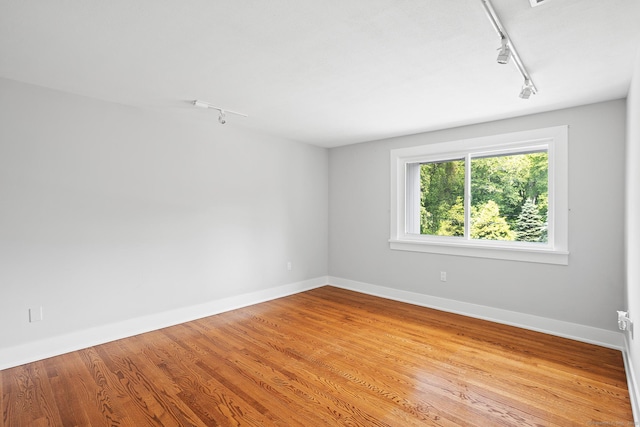 37 Topfield Rd, Wilton, CT 06897 - spare room with rail lighting, wood finished floors, and baseboards