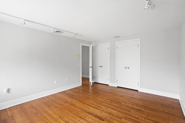 37 Topfield Rd, Wilton, CT 06897 - empty room featuring track lighting, wood finished floors, and baseboards