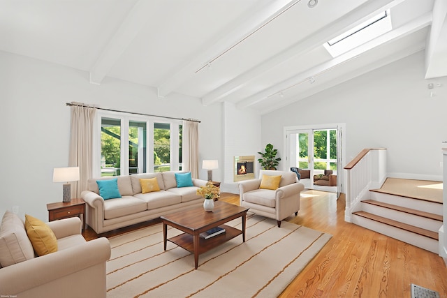 37 Topfield Rd, Wilton, CT 06897 - living area with beam ceiling, light wood-style floors, a skylight, high vaulted ceiling, and stairs