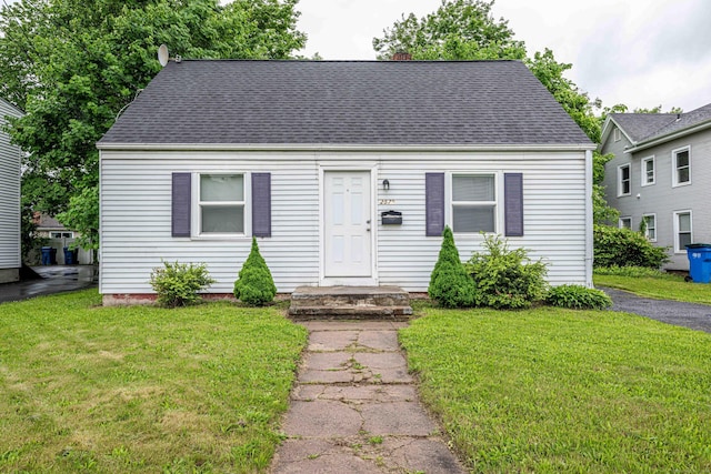 2579 Whitney Ave, Hamden, CT 06518 - cape cod house featuring a front yard, roof with shingles, and a chimney