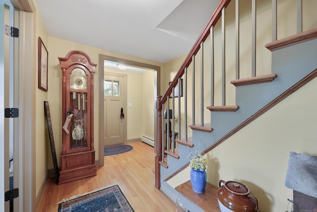 50 Clinton St, Glastonbury, CT 06033 - foyer featuring wood finished floors, stairs, a baseboard heating unit, and baseboards