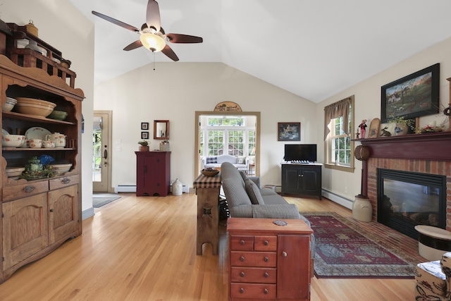 50 Clinton St, Glastonbury, CT 06033 - living area with a baseboard heating unit, a ceiling fan, light wood-type flooring, lofted ceiling, and a fireplace
