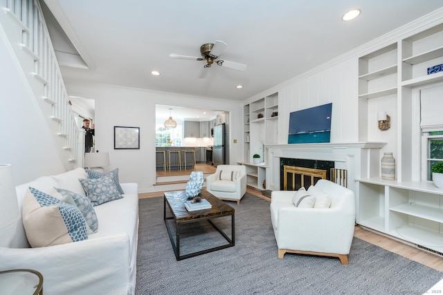 19 Bryan Rd, Norwalk, CT 06853 - living area with ornamental molding, wood finished floors, a ceiling fan, stairway, and recessed lighting