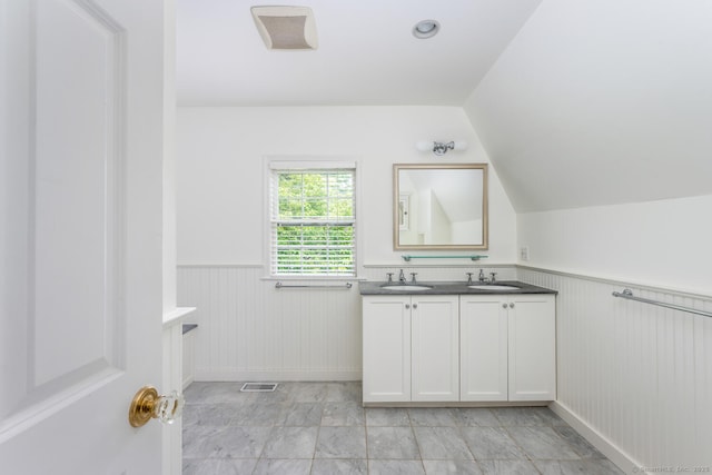 19 Bryan Rd, Norwalk, CT 06853 - bathroom with wainscoting, double vanity, and vaulted ceiling