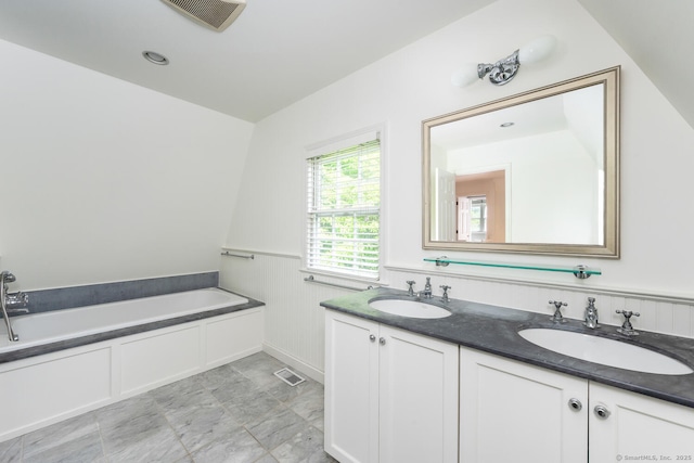 19 Bryan Rd, Norwalk, CT 06853 - full bathroom featuring double vanity, a bath, and a wainscoted wall