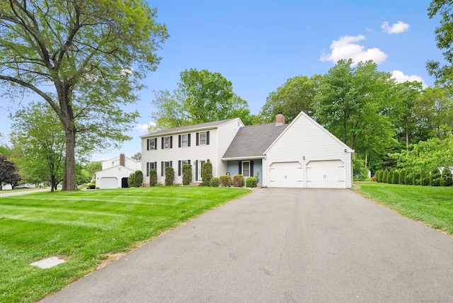 132 Royal Oak Dr, Southington, CT 06489 - colonial-style house with a chimney, a garage, asphalt driveway, and a front yard