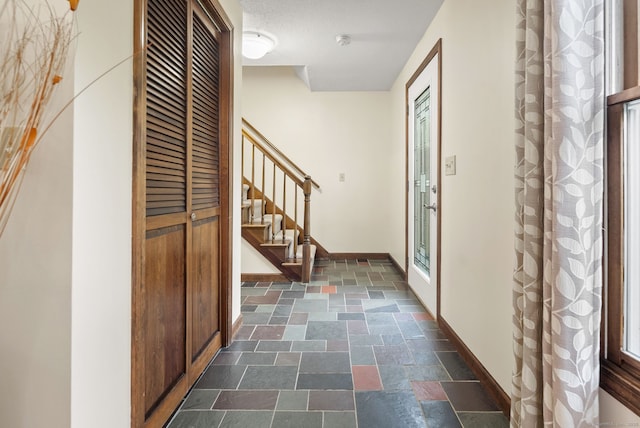 132 Royal Oak Dr, Southington, CT 06489 - entryway with dark stone finish flooring, stairs, and baseboards