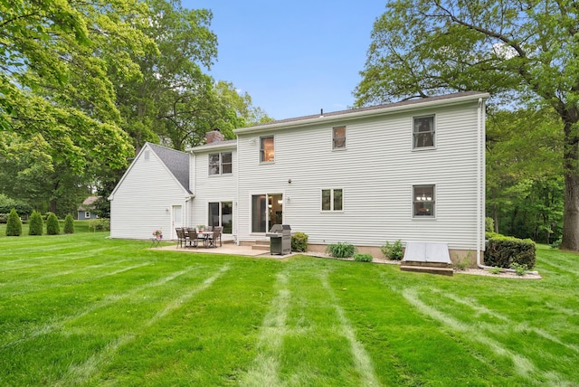 132 Royal Oak Dr, Southington, CT 06489 - rear view of house with a yard, a patio area, and a chimney