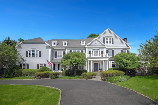 134 Nod Rd, Ridgefield, CT 06877 - view of front of property with a chimney, a balcony, and a front lawn