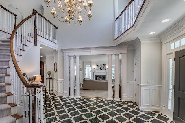 134 Nod Rd, Ridgefield, CT 06877 - foyer entrance featuring a high ceiling, a decorative wall, inlaid floor details, stairway, and a fireplace
