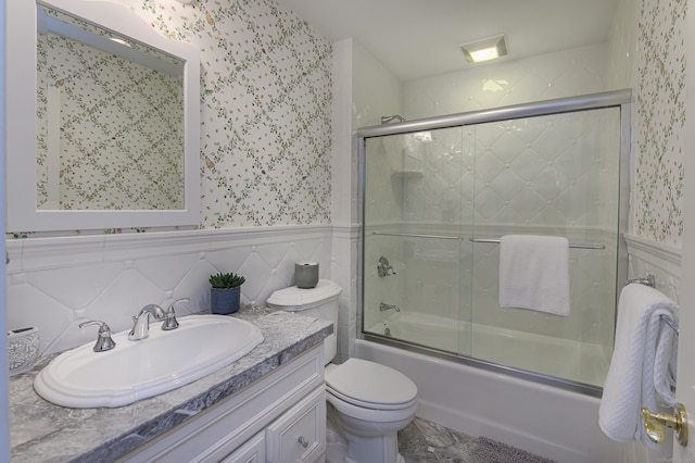 134 Nod Rd, Ridgefield, CT 06877 - bathroom with vanity, shower / bath combination with glass door, toilet, wallpapered walls, and a wainscoted wall