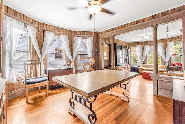 441 Savin Ave, West Haven, CT 06516 - dining area with ornate columns, wood walls, a ceiling fan, light wood finished floors, and crown molding
