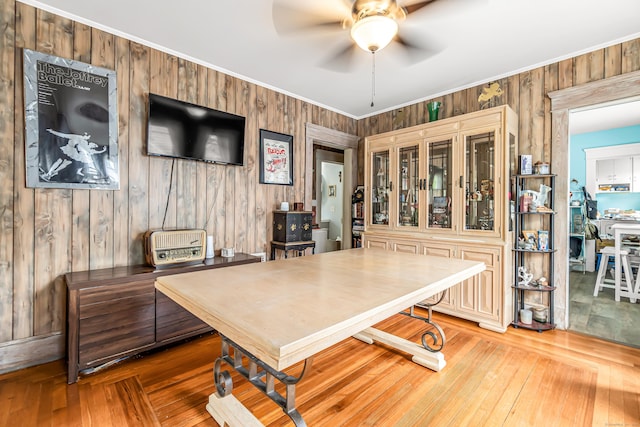 441 Savin Ave, West Haven, CT 06516 - dining space with a ceiling fan, crown molding, wooden walls, and wood finished floors