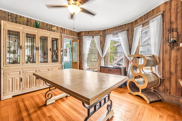 441 Savin Ave, West Haven, CT 06516 - dining room with ceiling fan, light wood-style floors, wood walls, and crown molding