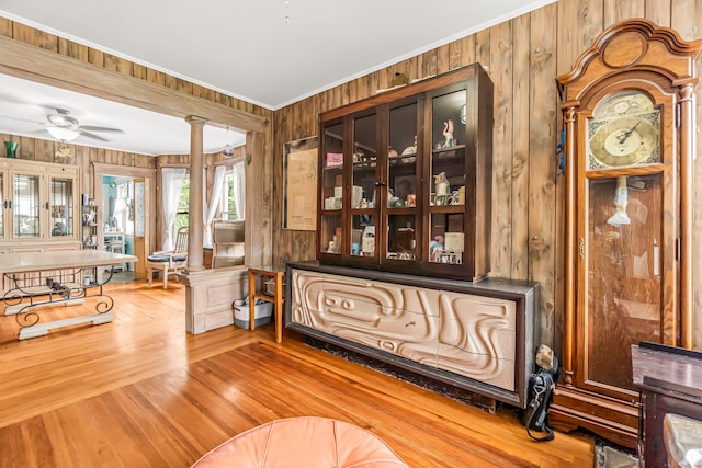 441 Savin Ave, West Haven, CT 06516 - living room with wood walls, decorative columns, ornamental molding, ceiling fan, and wood finished floors