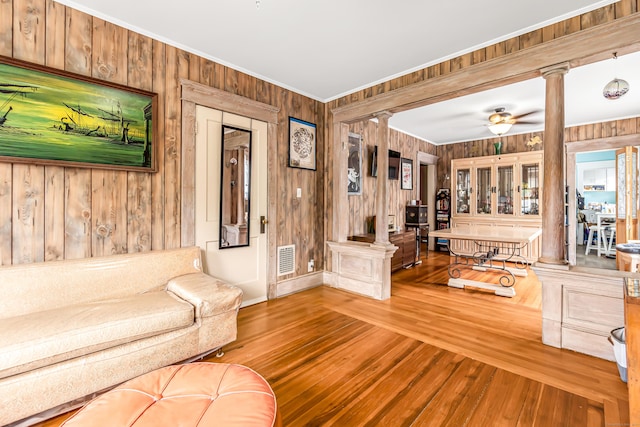 441 Savin Ave, West Haven, CT 06516 - living area featuring ornate columns, wood walls, ornamental molding, wood-type flooring, and ceiling fan