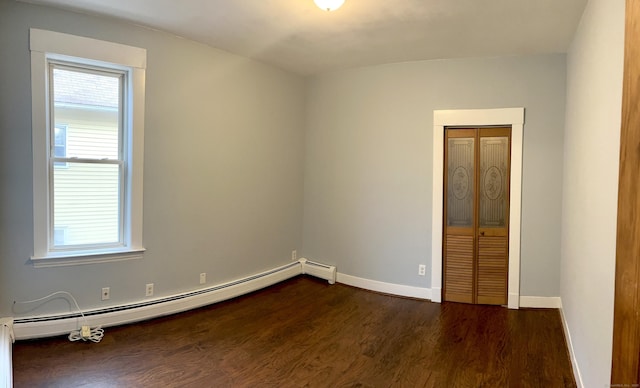 47 Beacon St, Hamden, CT 06514 - unfurnished room with dark wood-type flooring, baseboard heating, and baseboards