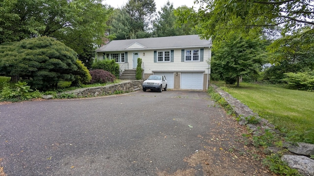 11 Twin Brooks Ln, Fairfield, CT 06824 - view of front facade featuring driveway, a garage, and a front yard