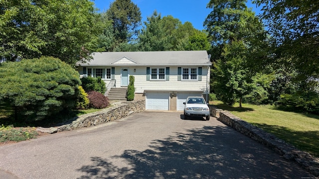 11 Twin Brooks Ln, Fairfield, CT 06824 - ranch-style house with asphalt driveway, a garage, and a front yard