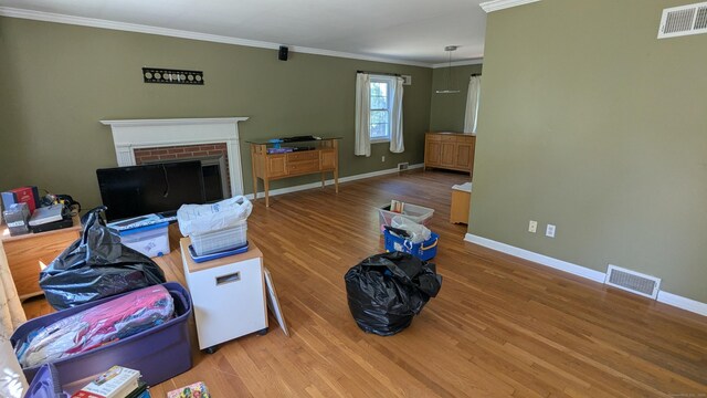 11 Twin Brooks Ln, Fairfield, CT 06824 - living area with wood finished floors, baseboards, crown molding, and a brick fireplace