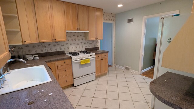 11 Twin Brooks Ln, Fairfield, CT 06824 - kitchen featuring white range with gas stovetop, a sink, dark countertops, light brown cabinets, and light tile patterned floors