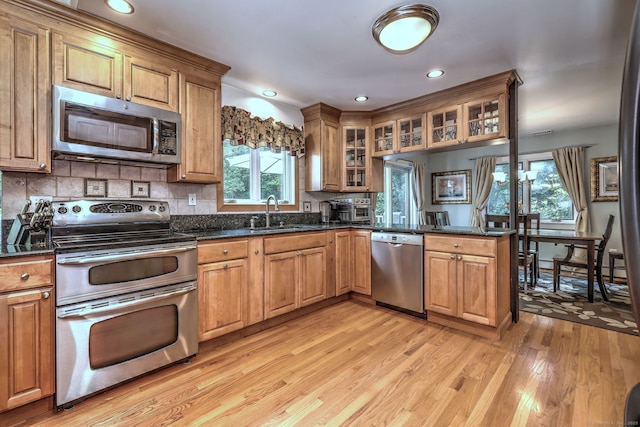 76 Crestwood Rd, Bethany, CT 06524 - kitchen featuring stainless steel appliances, a sink, light wood-type flooring, glass insert cabinets, and tasteful backsplash