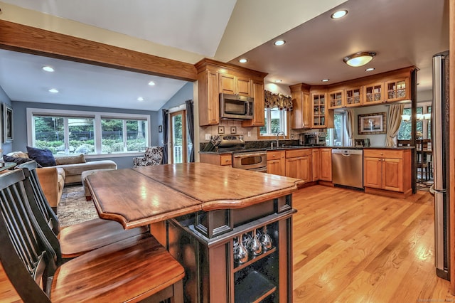 76 Crestwood Rd, Bethany, CT 06524 - kitchen featuring stainless steel appliances, vaulted ceiling, dark countertops, light wood finished floors, and a sink