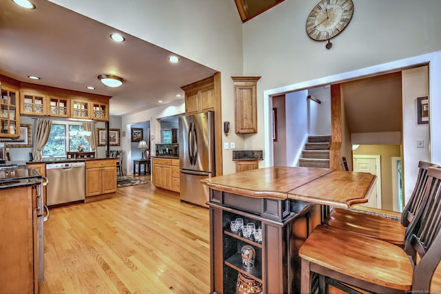 76 Crestwood Rd, Bethany, CT 06524 - kitchen featuring appliances with stainless steel finishes, light wood-style floors, dark countertops, glass insert cabinets, and recessed lighting