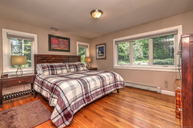 76 Crestwood Rd, Bethany, CT 06524 - bedroom featuring baseboard heating, wood finished floors, and baseboards