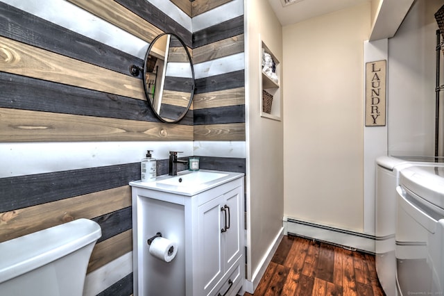 76 Crestwood Rd, Bethany, CT 06524 - half bath with toilet, washing machine and dryer, a baseboard heating unit, vanity, and wood finished floors