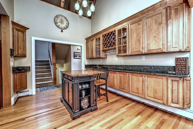 76 Crestwood Rd, Bethany, CT 06524 - kitchen featuring a high ceiling, baseboard heating, light wood-style flooring, and brown cabinetry
