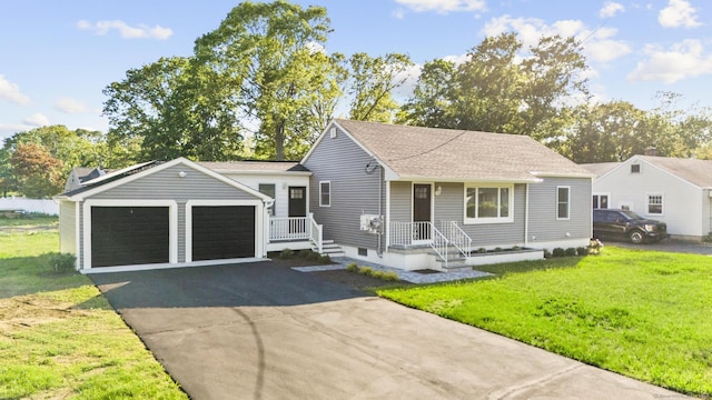 48 Blakeslee Ave, North Haven, CT 06473 - view of front of property with a front yard, asphalt driveway, a garage, and a shingled roof