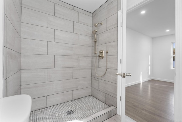 48 Blakeslee Ave, North Haven, CT 06473 - bathroom featuring tiled shower, wood finished floors, recessed lighting, baseboards, and toilet