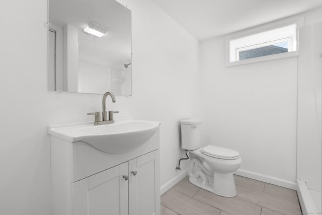 48 Blakeslee Ave, North Haven, CT 06473 - bathroom featuring vanity, toilet, baseboards, and wood finish floors