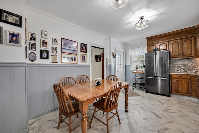 273 Piedmont St, Waterbury, CT 06706 - dining room featuring light marble finish flooring, wainscoting, and crown molding