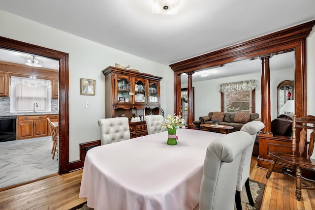 273 Piedmont St, Waterbury, CT 06706 - dining room featuring light wood-style flooring and decorative columns