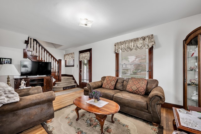 273 Piedmont St, Waterbury, CT 06706 - living room with wood finished floors, stairway, and baseboards