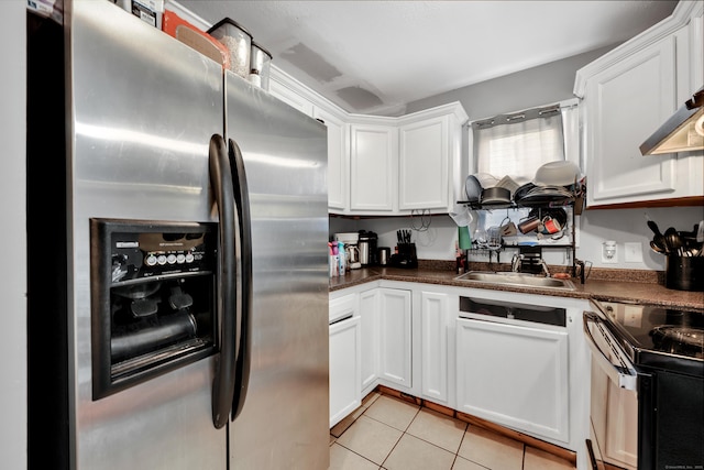 68 Round Tree Dr Unit 9, Naugatuck, CT 06770 - kitchen featuring stainless steel appliances, white cabinets, dark countertops, light tile patterned floors, and a sink