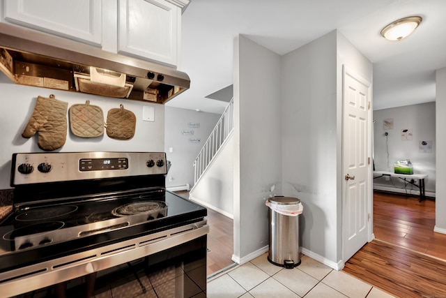 68 Round Tree Dr Unit 9, Naugatuck, CT 06770 - kitchen featuring stainless steel range with electric cooktop, white cabinets, light wood-style flooring, and baseboards